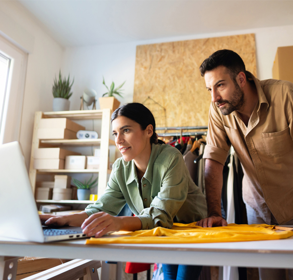 woman and man in retail shop using laptop